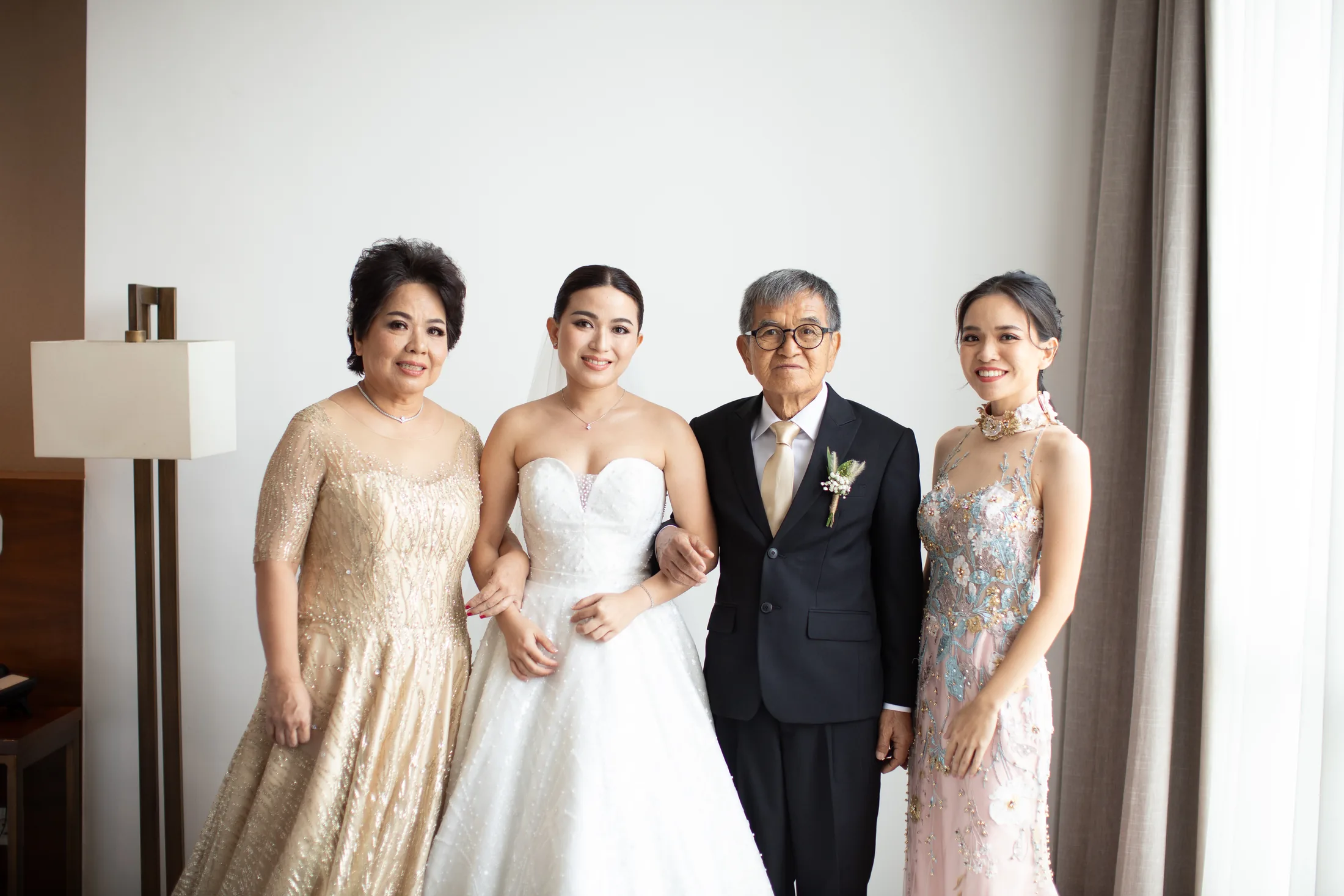 Bride with family members in formal occasion gowns