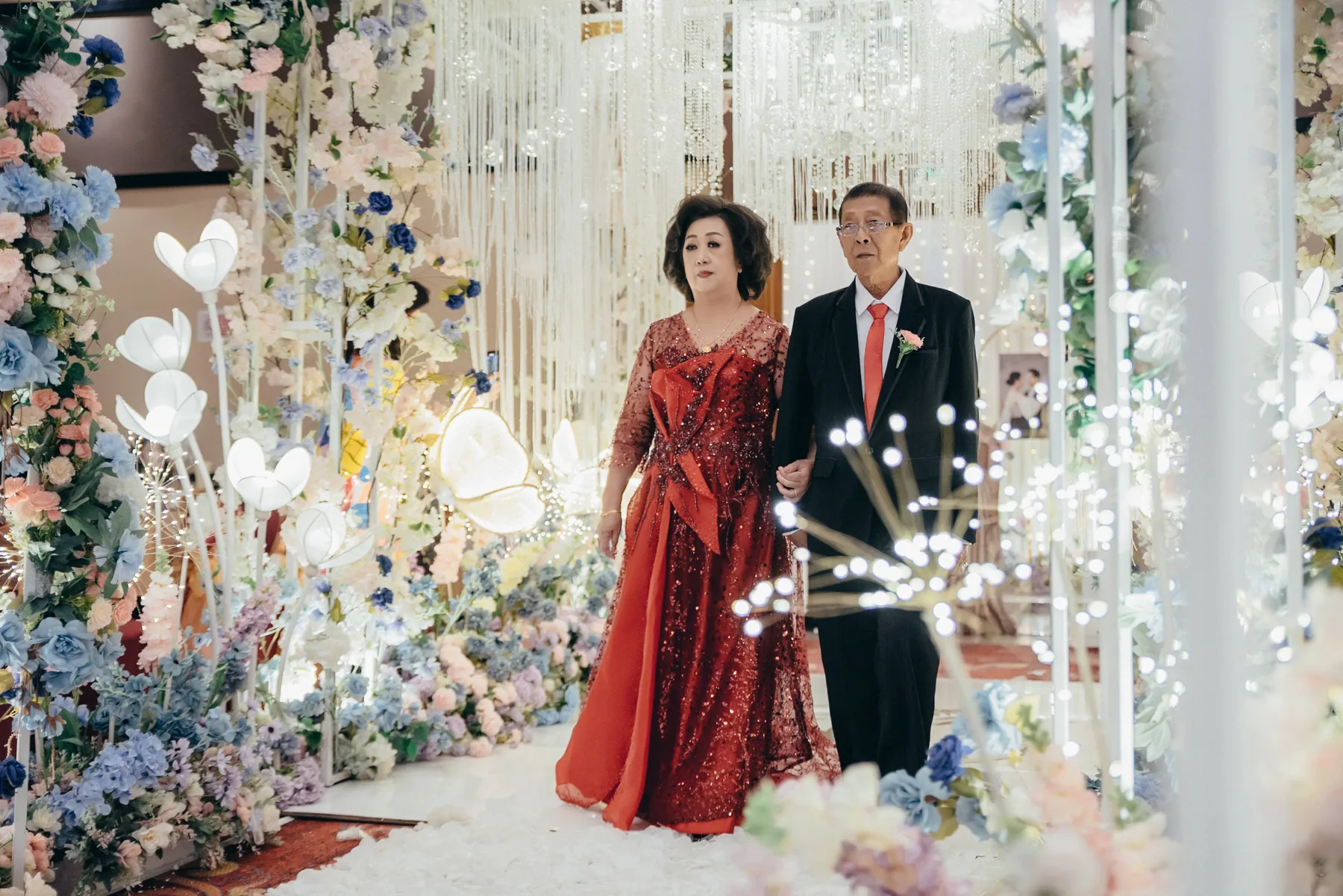 Woman in a formal red gown at a wedding celebration