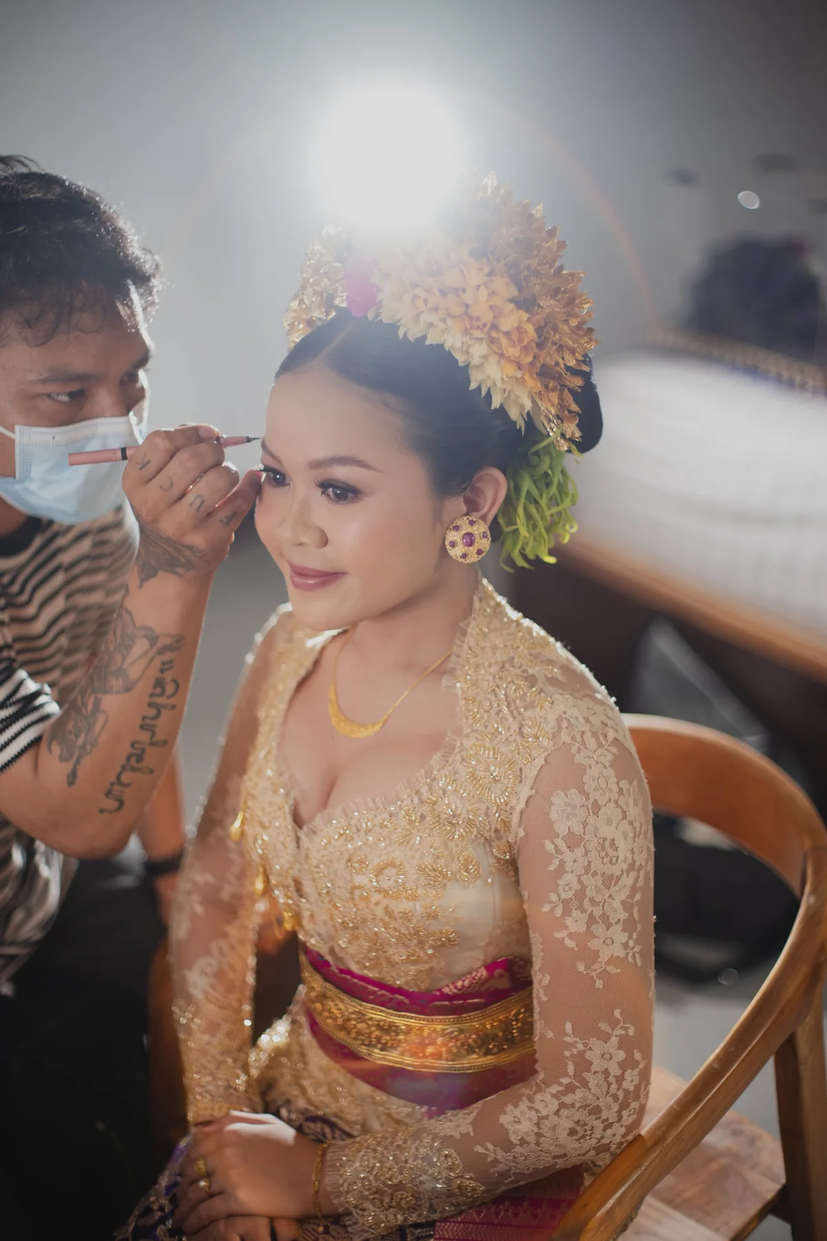 Agus working beside a bride during her makeup appointment
