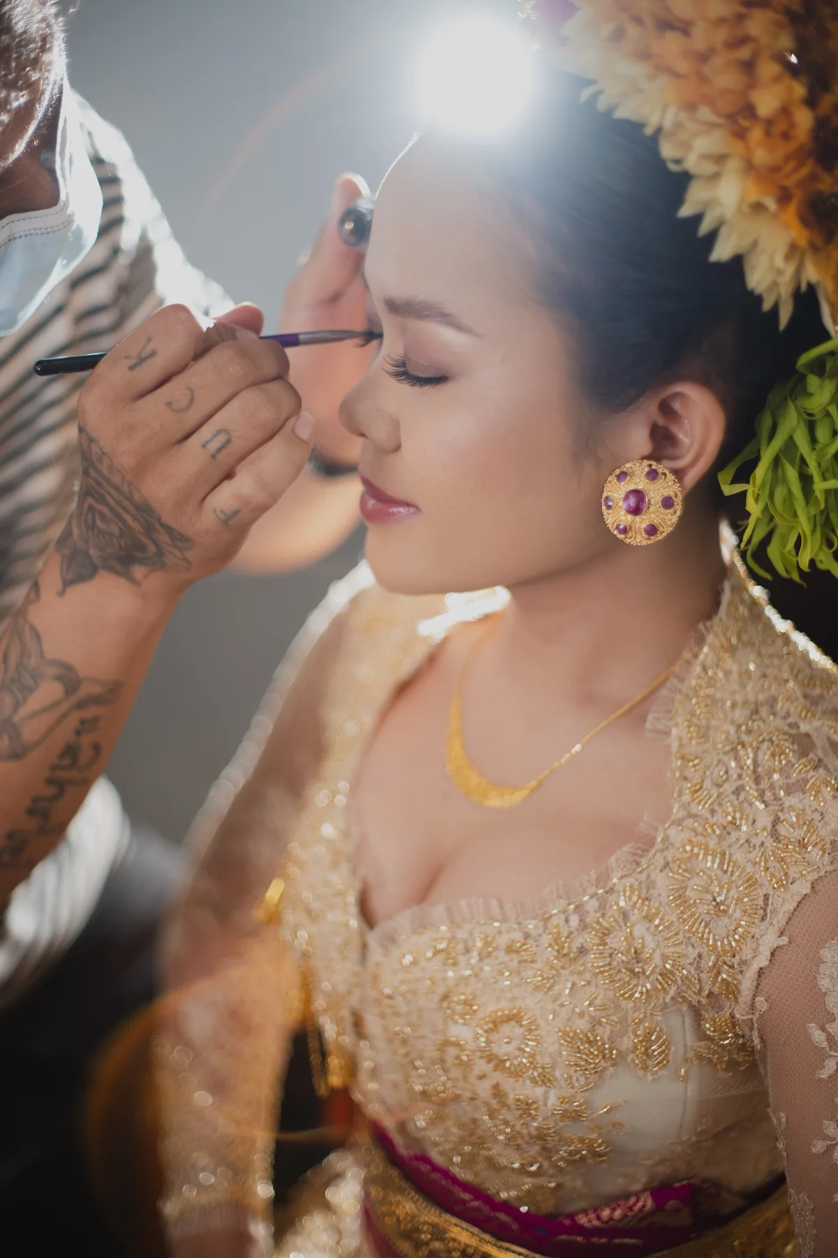 A close-up of careful eye makeup application during bridal preparation