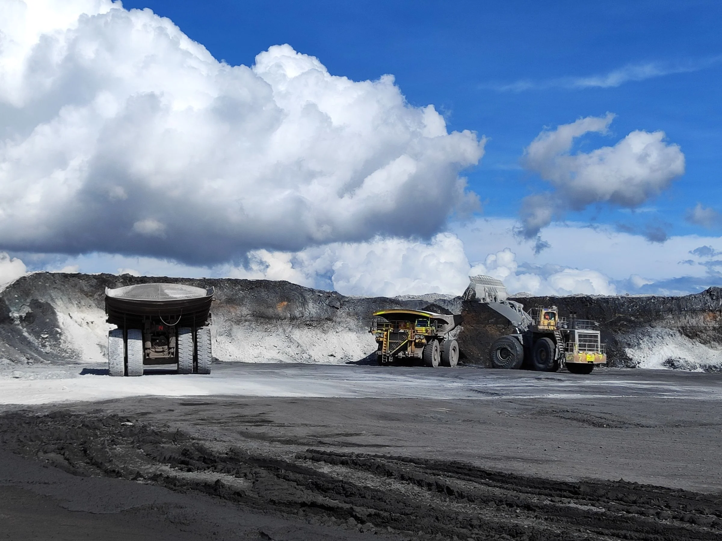 Open-pit mine with trucks and excavators, illustrative mining industry photography