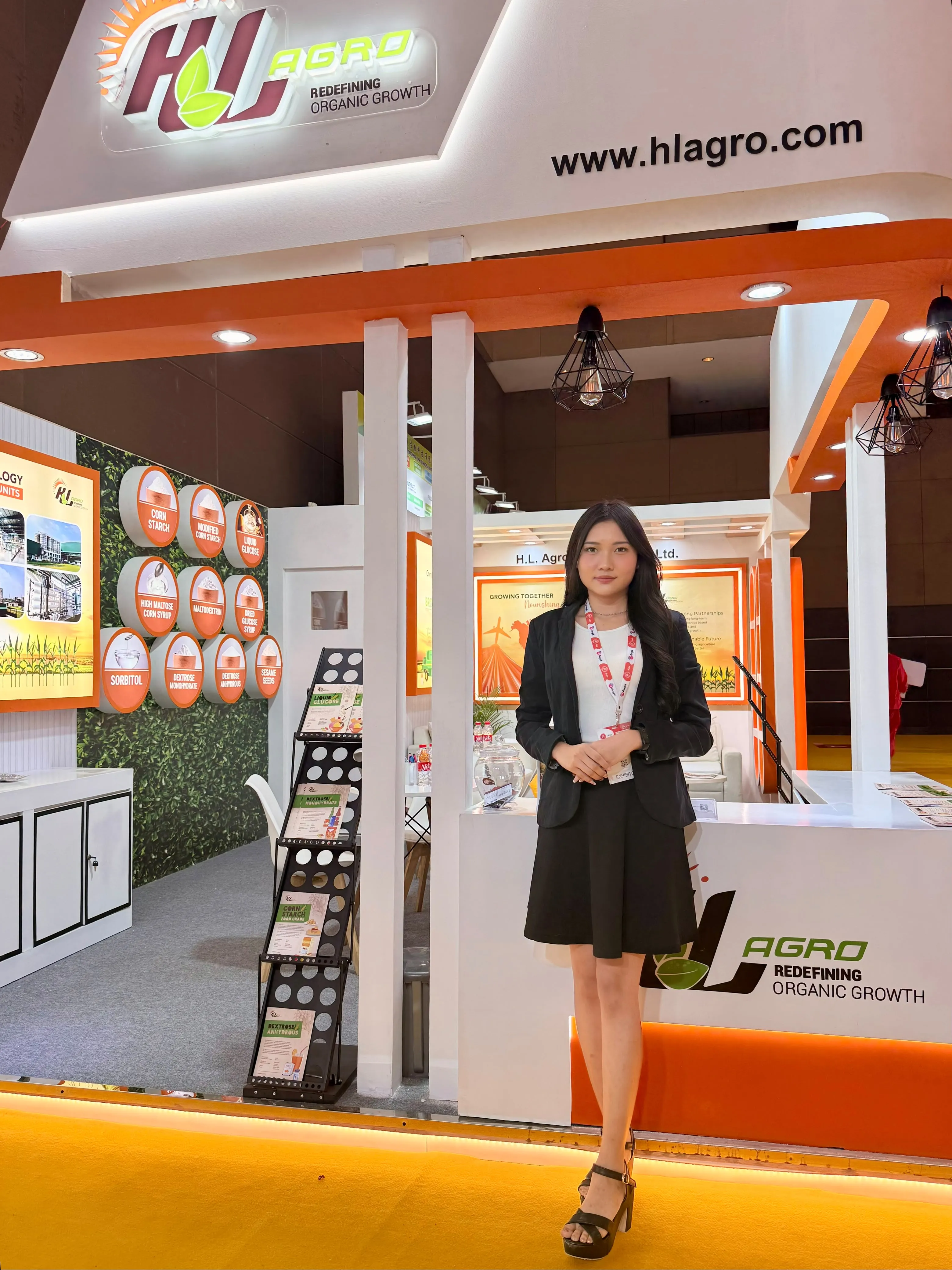 Usher welcoming guests at the H.L. Agro booth